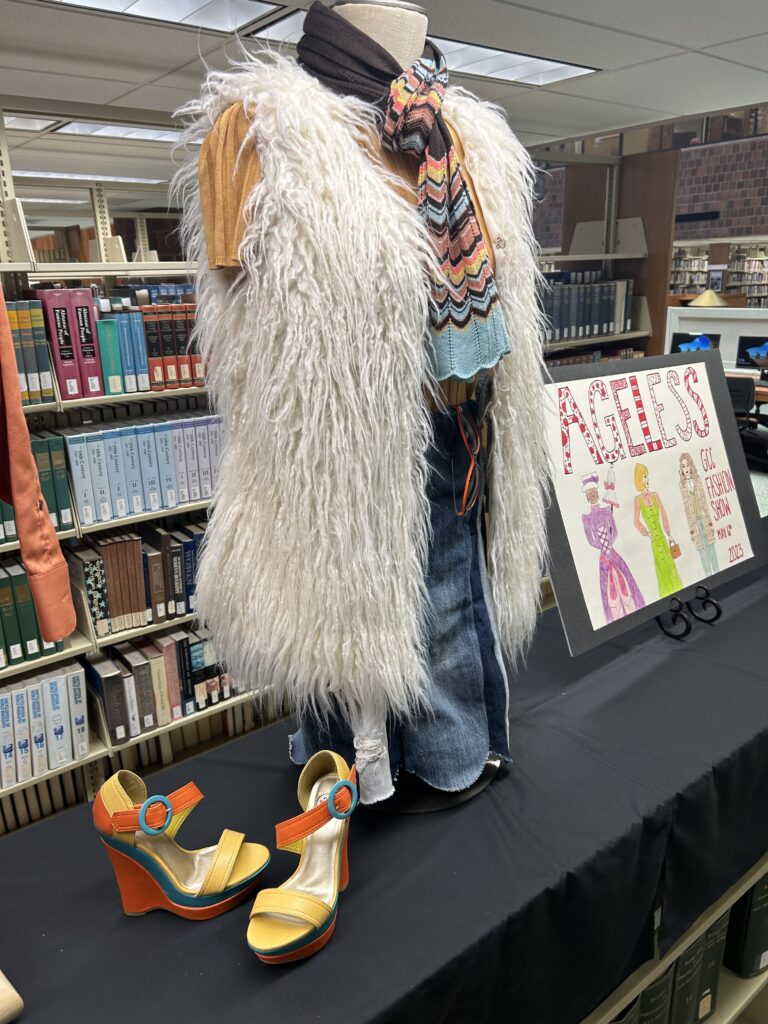 Fashion show library display with colorful sandal pumps and fuzzy vest/skirt /scarf outfit