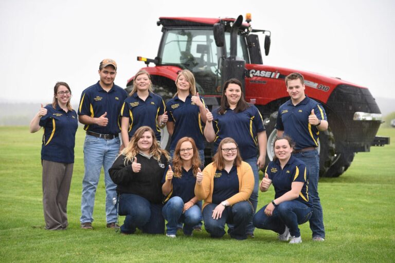 A group of students by a tractor